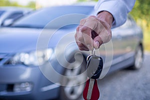 The owner or sales representative is sending the rental car keys to the buyer or the renter. Concept cars with finance or auto