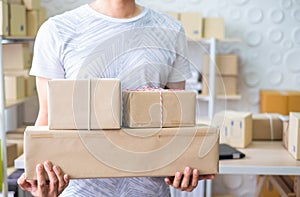 Owner, start up small business. Man holding boxes working, Ready for delivery at home office.