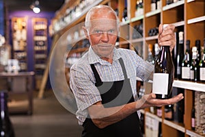 Owner of wine shop offering wine