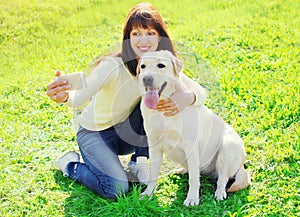Owner woman with labrador retriever dog taking selfie portrait