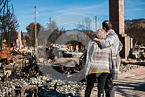 Owners, checking burned and ruined house and yard after fire