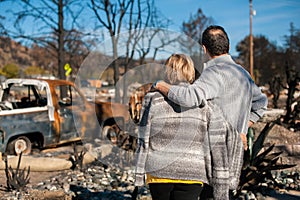 Owners, checking burned and ruined house and yard after fire