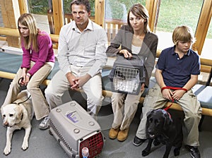 Owners Sitting In Vets Reception Area