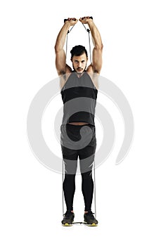 Owning this workout. Studio shot of a young man working out with a resistance band against a white background.