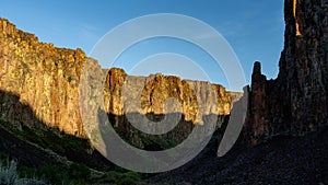 Owyhee desert canyon at sunrise with shadow