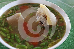 Ox\'s tail soup in white bowl.