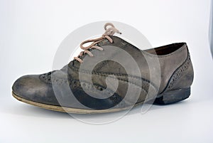 Oxford shoes with gray shoelaces on a flat heel. Gray women`s shoes in a fastening, unwitting.