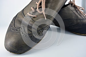 Oxford shoes with gray shoelaces on a flat heel. Gray women`s shoes in a fastening, unwitting.
