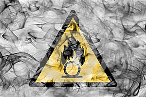 Oxidising materials hazard warning smoke sign. Triangular warning hazard sign, smoke background.