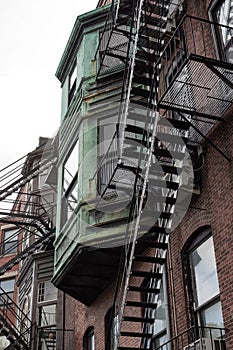 Oxidized copper detail on rear of brownstone rowhouse metal fire escapes