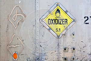 Oxidizer placard on decayed metal container photo