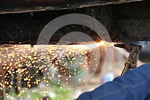 Oxy-Acetylene torch cutting through steel hull photo