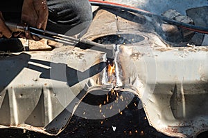 Oxy-Fuel Cutting Torch to cutting car for metal recycling.