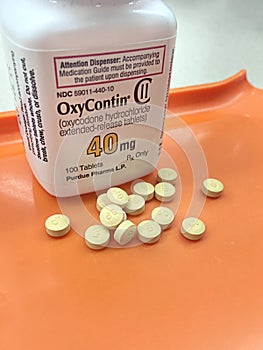 Oxycodone bottle on pharmacy tray with tablets poured out