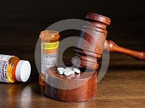 Oxycodone opioid tablets with judge gavel for court decision about liability photo