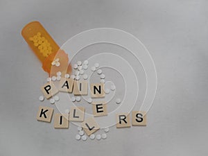 Oxycodone and Pain Killers Spelled with Scattered Tiles on Stain photo