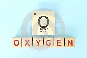 Oxygen chemical element symbol with atomic mass and atomic number in wooden blocks flat lay composition.