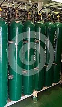 Oxygen cylinder with compressed gas. Green ooxygen tanks for industry. Liquefied oxygen production. Factory