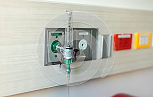 Oxygen flow meter plugged in the green outlet on hospital wall, Medical equipment. Oxygen for patients in the wall.