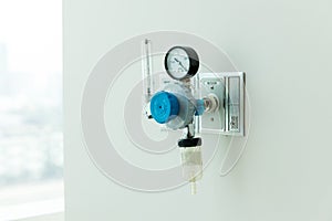 Oxygen flow meter plugged in the green outlet on hospital wall, Medical equipment. Oxygen for patients in the wall. Oxygen Gas Pip