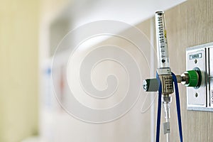 Oxygen flow regulator with tube scale for patients respirator or medical installed in the wall in room at hospital with copy space