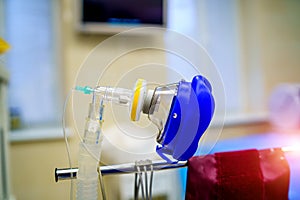 Oxygen mask as part of artificial lungs ventilation machine in surgery room, closeup