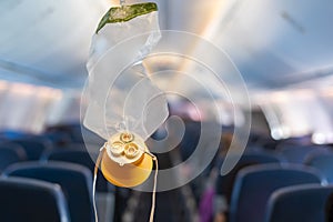 oxygen mask drop from the ceiling compartment on airplane