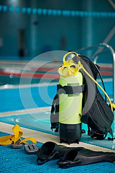 An oxygen tank at poolside, diving equipment