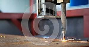 Oxygen torch cuts steel sheet. CNC gas cutting machine. Bright sparks