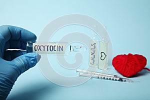 Oxytocin in ampoules. Decrease hormone and diagnostics. Heart and love concept