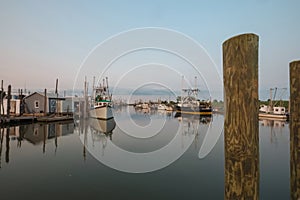 Oyster and fishing trawlers docked at sunset