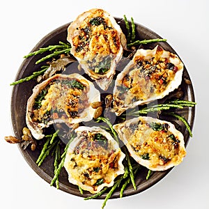 Oysters with Cheesy Gratin Topping Served on Plate photo