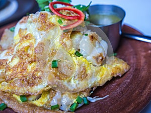 Oysters fried in egg batter with chili sauce