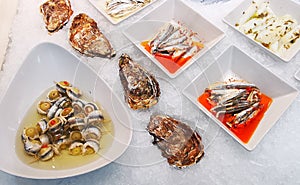Oysters and sardine fillets with olives