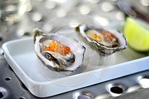 Oysters served with salmon roe
