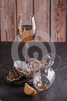 Oysters on the table with lemon and white wine