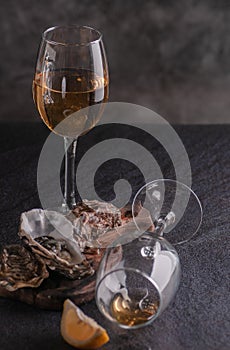 Oysters on the table with lemon and white wine