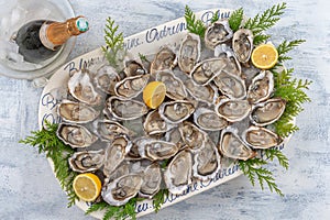 Oysters and white wine in a restaurant on wooden background