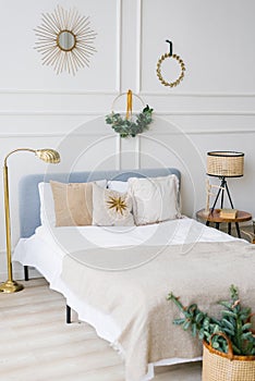 Ð¡ozy bedroom with bed and christmas garland lights at home