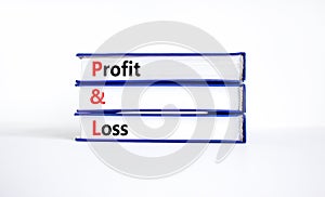 P and L profit and loss symbol. Concept words P and L profit and loss on books on a beautiful white table, white background.