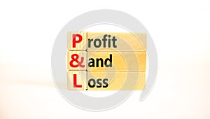 P and L profit and loss symbol. Concept words P and L profit and loss on wooden blocks on a beautiful white table, white