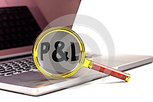 P and L word on magnifier on laptop , white background photo