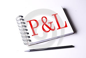 P AND L word on notebook on white background