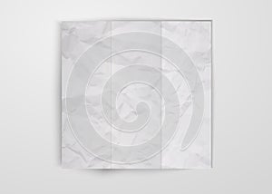 Three times folded white crumpled paper sheet placed on white background. Texture of crumpled paper square card template design photo