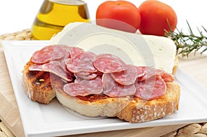 pa amb tomaquet amb fuet, bread with tomato and a typical sausage of Catalonia, Spain photo