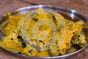 Pabda or Indian butterfish curry prepared with mustard sauce in traditional Bengali culinary style.