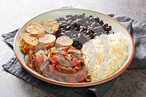 Pabellon criollo is a traditional dish of Venezuela with black beans, rice, plantains and shredded steak that have been cooked
