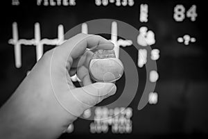 an pacemaker is held in front of an ECG monitor