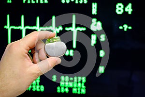 an pacemaker is held in front of an ECG monitor