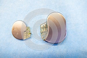 Pacemaker and an implantable defibrillator lying on a light blue base